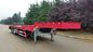 3 Axle Low Bed Semi Trailer Warna Merah Dengan Gandar Kemudi Mandiri dan Ramp Hidraulik